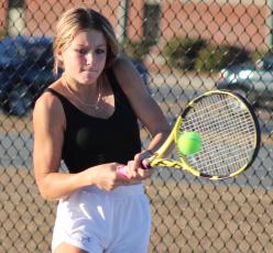 Hannah Coffman stings a backhand in a recent practice at the Wildcat courts. (Andy Diffenderfer, Tribune & Georgian)