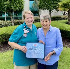 Camden County Volunteer Services President Kathleen Worthing, left, presents Sue Bearry with the Camden Campus Spring Volunteer of the Quarter award.